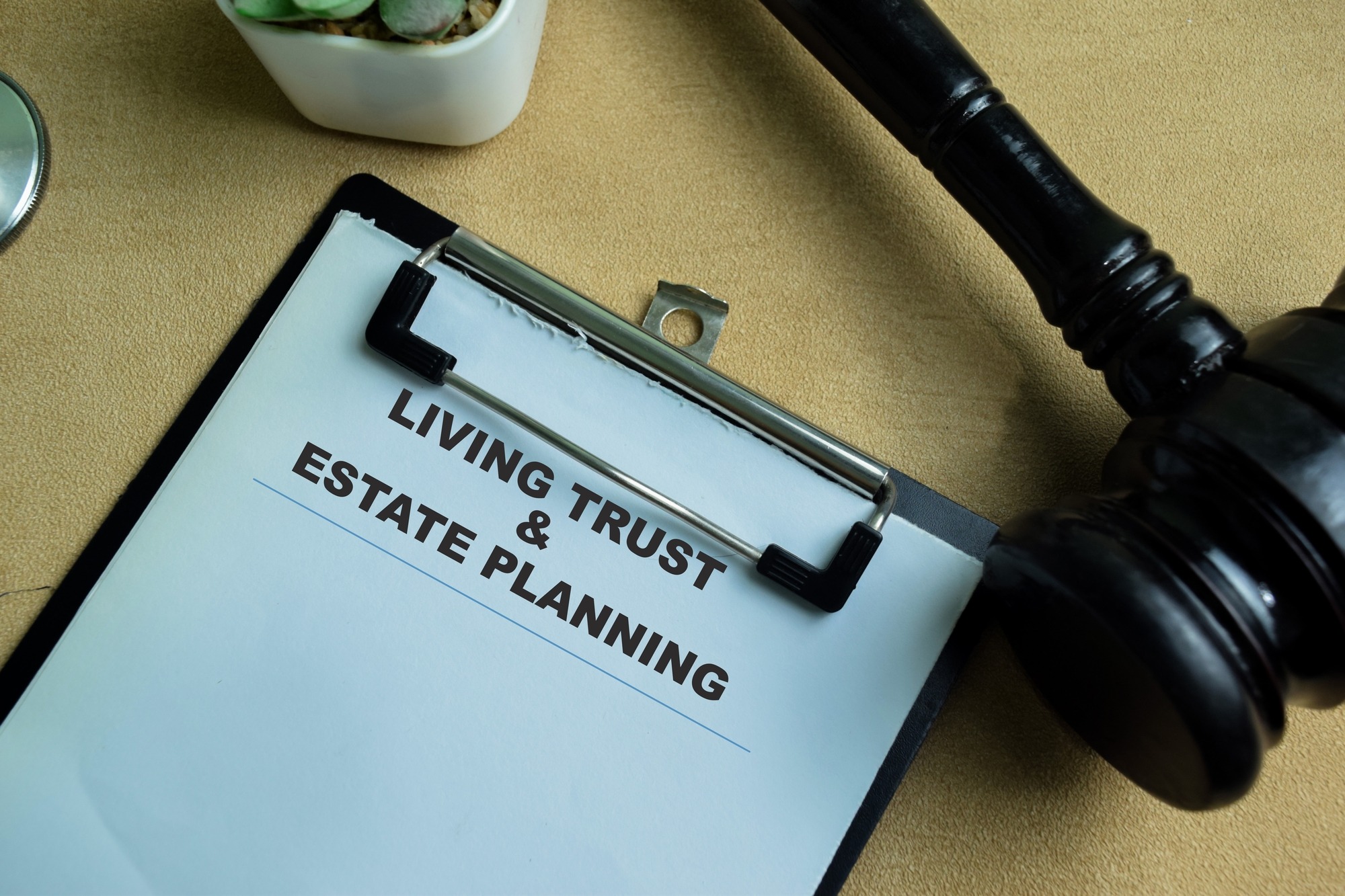 Concept of Living Trust and Estate Planning Write on Paperwork Isolated on Wooden Background.